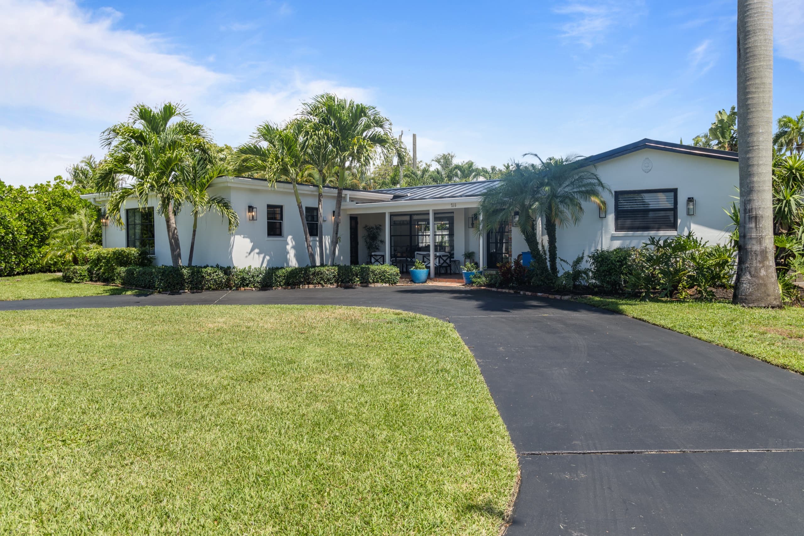 Casa L'Aqua exterior and tropical front yard in Boynton Beach, Florida
