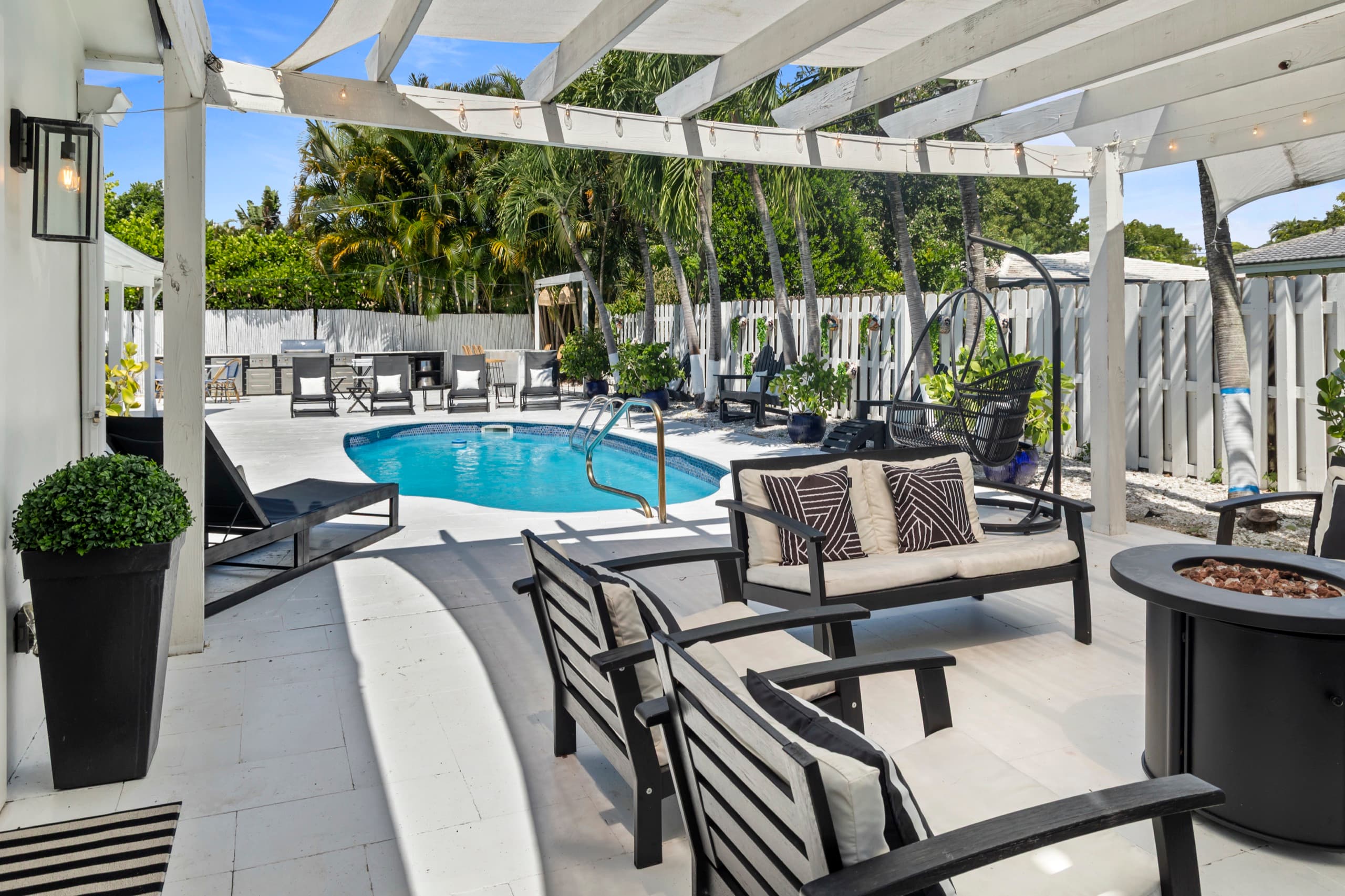 Pool deck with a shaded pergola lounge